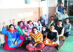 Members of the SSA, RMSA Non-Teaching Employees Union protest outside the DEO office in Bathinda on Friday.