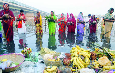 Devotees seek blessings of the Sun during the Chhath Puja on a ghat in the Yamuna on Friday.