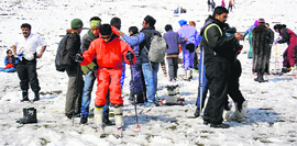 Tourists enjoy in the Solang valley, 13 km from Manali, on Friday.
