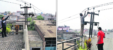 A resident shows high-tension wires passing through a residential locality; and (right) PSPCL staff fix the wire that was snapped in  Globe Colony, Jalandhar, on Friday. 