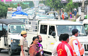 Commuters caught in a traffic jam at BSF Chowk due to the visit of the Chief Minister and Deputy Chief Minister to Jalandhar on Friday. 
