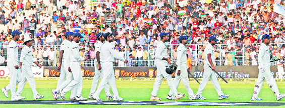 MS Dhoni leads his troops off the ground after decimating West Indies by an innings and 51 runs within just three days in Kolkata. The next Test will be held in Mumbai from November 14.