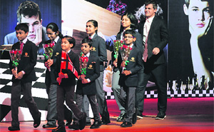 Magnus Carlsen follows children onto a stage in Chennai. The Norwegian is billed as favourite to win the title from defending champion Viswanathan Anand. 