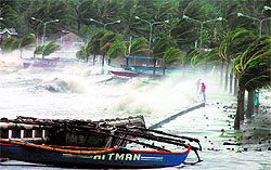 High waves pound against a sea wall amidst strong winds as Typhoon Haiyan hit Legaspi city in Manila on Friday