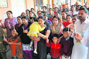 Teachers of unaided schools hold a candlelight protest in support of their demands in Bathinda on Saturday. 