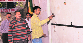 MC workers remove encroachments from Shastri Market in Sector 22 on Saturday.