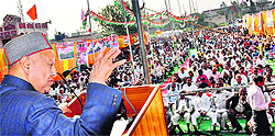 Chief Minister Virbhadra Singh addresses a gathering during a rally at Santokhgarh in Una district on Saturday