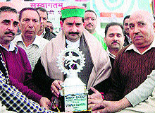 KS Pathania, vice-chairman, HP Forest Corporation, being honoured at a function at Chari in Kangra on Friday