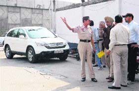 Police personnel inspect the site of crime at a petrol pump in Jalandhar on Saturday