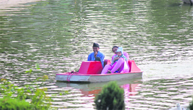 Visitors enjoy boating at the artificial lake in the Bagh-e-Bahu park in Jammu on Saturday.