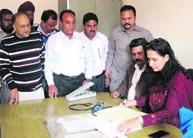 Navjot Kaur, CPS, checks the attendance register at a health centre in Attari on Saturday