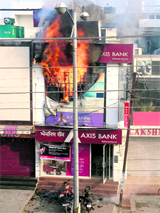 Flames engulf the first floor of the building of the Axis Bank on the Mall road in Bathinda on Sunday morning.