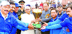 Governor of Haryana Jagannath Pahadia presents a trophy to the winners of the 14th All-India Police Lawn Tennis Championship at the CLTA in Chandigarh
