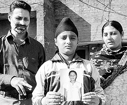 A resident of Chhatbir along with his family shows a photograph of their daughter, who died of a snakebite last year; and (right) a snake spotted at the house