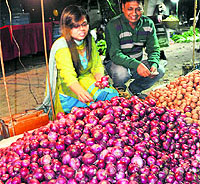 Residents buy onions at the Sector 38 Apni Mandi on Sunday