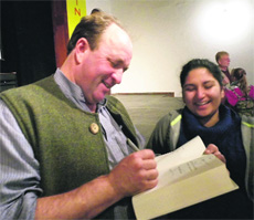Willaim Darlyample gives autograph to a woman during the writers festival in Mussoorie. 