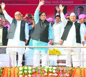 Chief Minister Bhupinder Singh Hooda, AICC general secretary Shakeel Ahmed and state Congress chief Phool Chand Mullana greet the gathering during the Haryana Shakti rally at Gohana in Sonepat district on Sunday