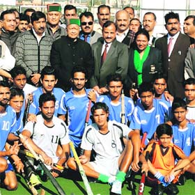 Members of the Kushal Singh Renny and Paramjeet Singh Lucky Hockey Association pose with Chief Minister Virbhadra Singh at Una on Sunday
