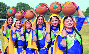 Girls pose with earthen pots during the virasati mela at Lyallpur Khalsa College