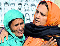 Association of Parents of Disappeared Persons chairperson Parveena Ahanger consoles the mother of a missing person in Srinagar on Sunday