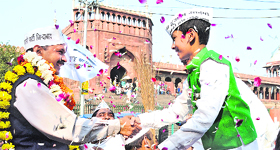 AAP leader Arvind Kejriwal being greeted by a boy near Jama Masjid in Old Delhi on Sunday.