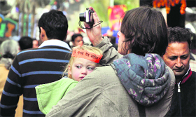 A foreign tourist with her child on The Mall in Shimla.
