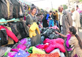 Winter Calling: Citizens busy purchasing woollen clothes from a roadside vendor near Lal Ratan Cinema in Jalandhar on Monday