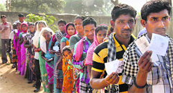 People wait to cast their votes at a polling booth in Dantewada during the first phase of polling for Chhattisgarh Assembly elections on Monday.  PTI