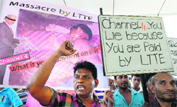 Protesters raise slogans against the arrivial of a crew from Britain's Channel 4 television at Bandaranaike International Airport in Sri Lanka on Monday.  AFP