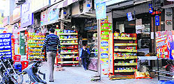 Shopkeepers display items in corridors, blocking the path, at Phase V