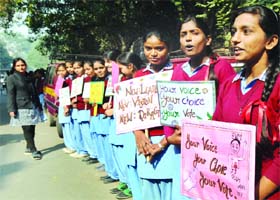 School girls make a human chain to create awareness about voting in New Delhi on Tuesday