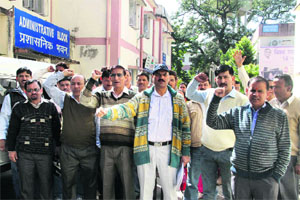 Striking pharmacists raise slogans in support of their demands at Doon Hospital on Tuesday. 