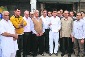 Members of the Wholesale Cloth Merchants Association hold their memorandum against VAT in Karnal on Tuesday