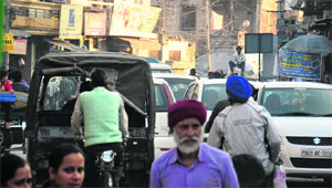 Commuters stuck in a traffic jam at Kishanpura Chowk in Jalandhar. 