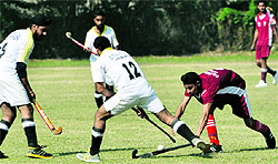 Players in action during the inter-college hockey tournament in Jammu on Tuesday