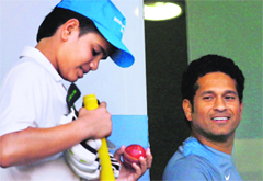 Sachin Tendulkar with son Arjun during a practice session ahead of the 2nd Test against West Indies in Mumbai on Tuesday.  PTI 