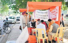 Residents gather information regarding property tax from a booth set up at Phase III B-2 in Mohali