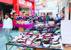 Small vendors sell their wares from space encroached upon at the Sector 7 market