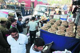 JMC employees remove encroachments at the Raghunath Bazaar in Jammu on Wednesday