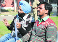 Akhil Ahmed (right), owner of SK Oil Traders Company, addresses a press conference in Ludhiana on Wednesday