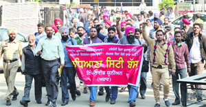 Drivers and conductors of Ludhiana City Bus Service Ltd hold a protest in Ludhiana on Wednesday.