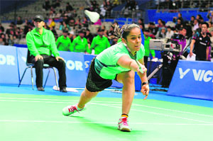 Saina Nehwal hits a return to Nozomi Okuhara of Japan in the first round at the China Open in Shanghai on Wednesday. Nehwal won the match 21-14, 21-19.