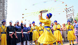 A girl plays gatka, a martial art, during a nagar kirtan carried out ahead of Guru Nanak Devs birth anniversary in Bathinda on Thursday