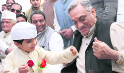 A child offers a flower to Chief Minister Vijay Bahuguna at the inauguration of Nehru Heritage Centre in Dehradun on Thursday. Tribune photo: Vinod Pundir 