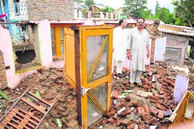 A file photograph of a house damaged in the May 1 earthquake in Doda district