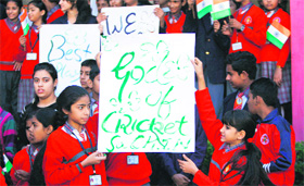 Schoolchildren display posters on Sachin Tendulkar in Jammu on Wednesday.