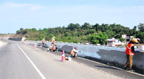 Labourers busy painting a divider on Jammu-Srinagar National Highway near Jagati township in Nagrota. The highway will connect the Kashmir valley to the rest of the country.