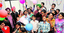 Members of the Young Writers Association celebrate the day with children who work in canteens at the PAU in Ludhiana