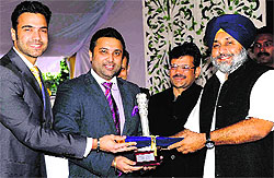 Kanwar Dhillon and Karan Dhillon, sons of Barnala MLA Kewal Dhillon, receive an award from Deputy CM in Chandigarh on Thursday
