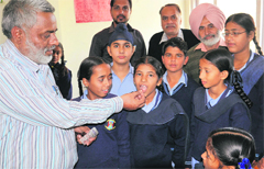 A dose of albendazole being administered to a student at Adarsh School in Bathinda on Friday. Tribune photo: Pawan Sharma